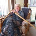 Elderly Lady Knits Fence